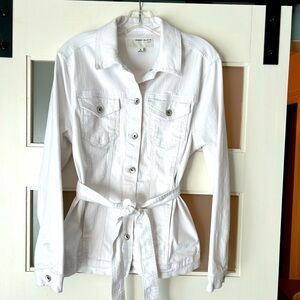 White jean jacket with belt around waist.